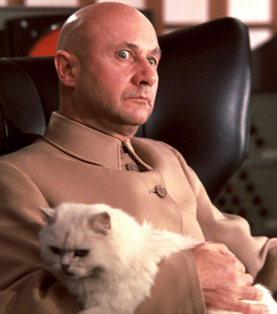 My depiction of Aristotle Krapaud here is definitely referencing the famous Bond villain Ernst Stavro Blofeld, whoâs usually seen stroking his cat. He appears in several of the novels and films. Hereâs Donald Pleasance in the role.