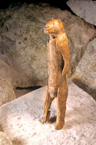 On the table in the foreground she has (presumably a copy) of the Löwenmensch, found in the Stadel Cave in Southern Germany. At 40,000 years old, itâs the oldest example of figurative art in the world and, yes, itâs anthropomorphic. People have told stories of anthromorphic characters as long as people have told stories, and there are many other prehistoric examples, including many cave paintings. Itâs carved from a woolly mammoth tusk and stands 31 cm high. Itâs disputed whether the lion-headed figure is male or female.